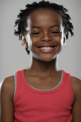A young Glaze patient with a joyful gap-toothed grin