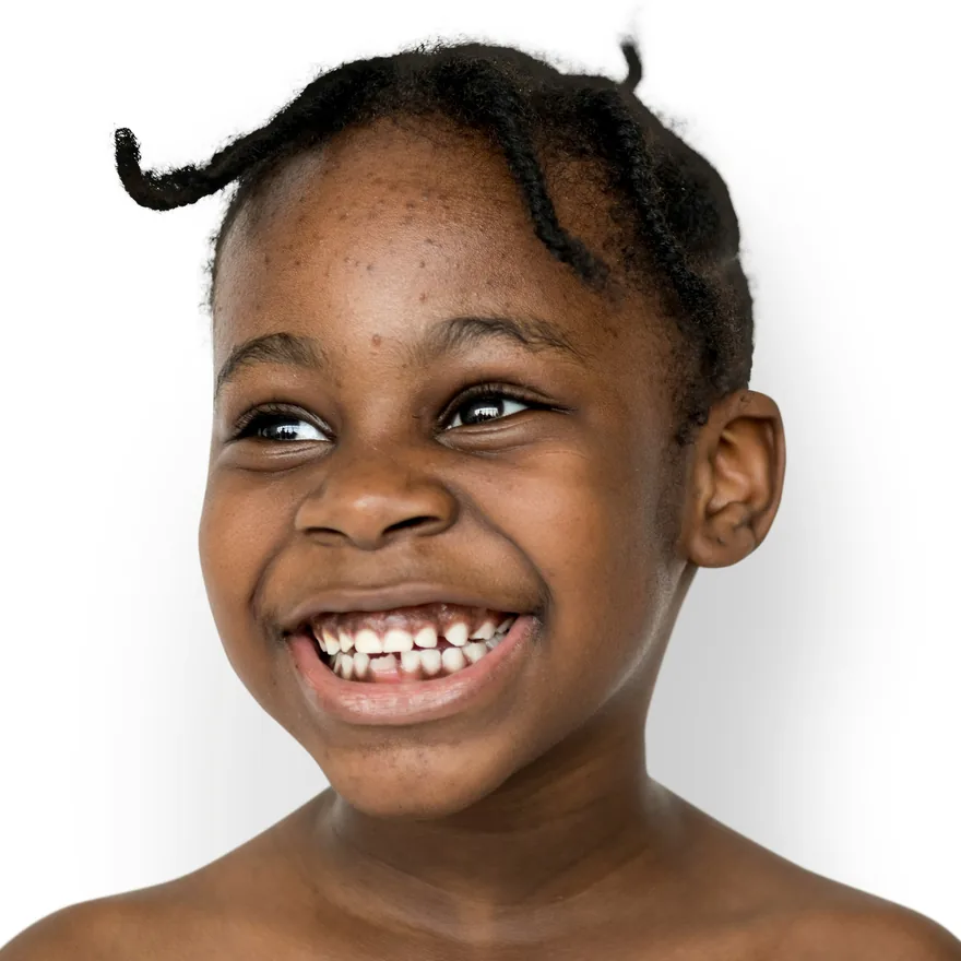 A young child laughing, baby teeth showing